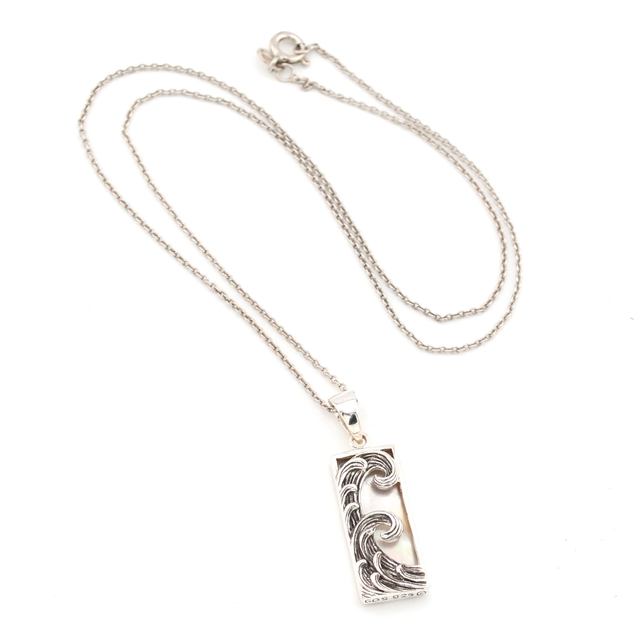 Silver necklace with a rectangular wave-pattern pendant on a white background