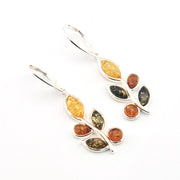 Silver earrings with multicolored gemstones on a white background
