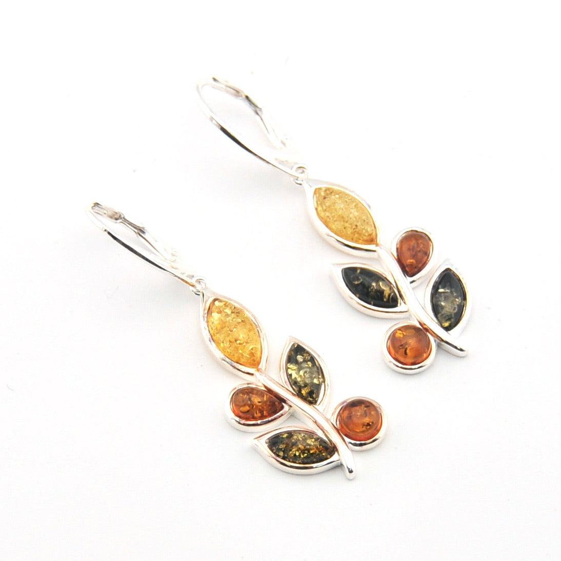 Silver earrings with multicolored gemstones on a white background