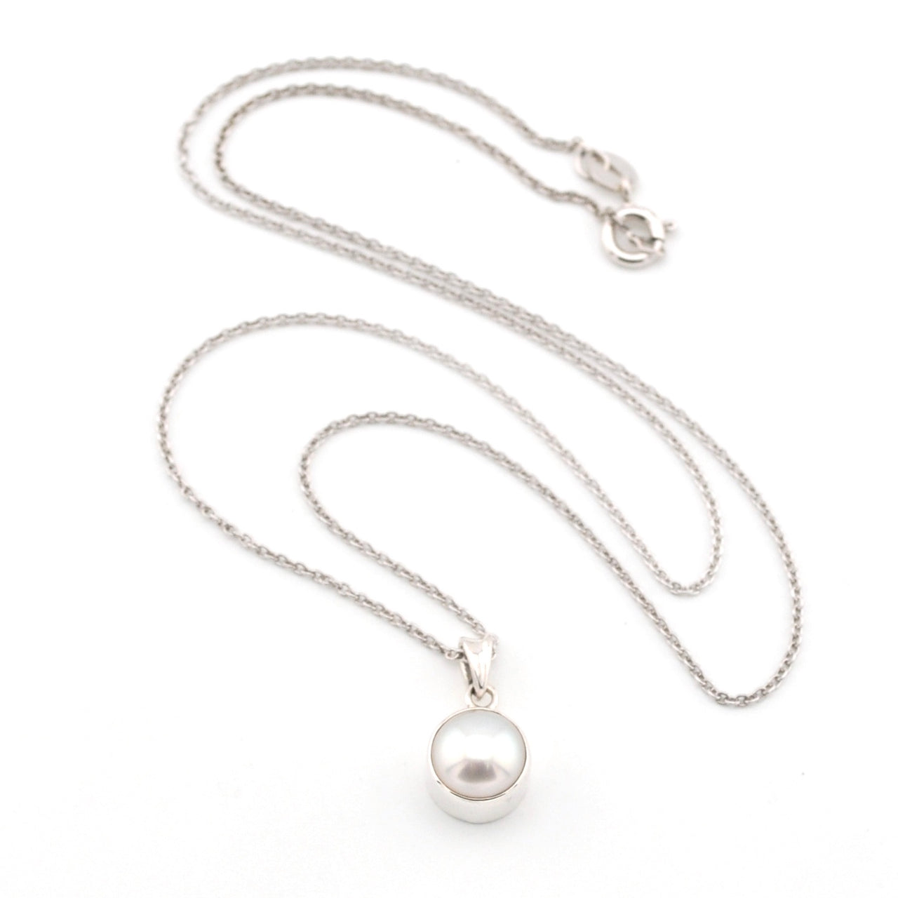 Pearl necklace with a silver chain on a white background