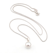 Pearl necklace with a silver chain on a white background