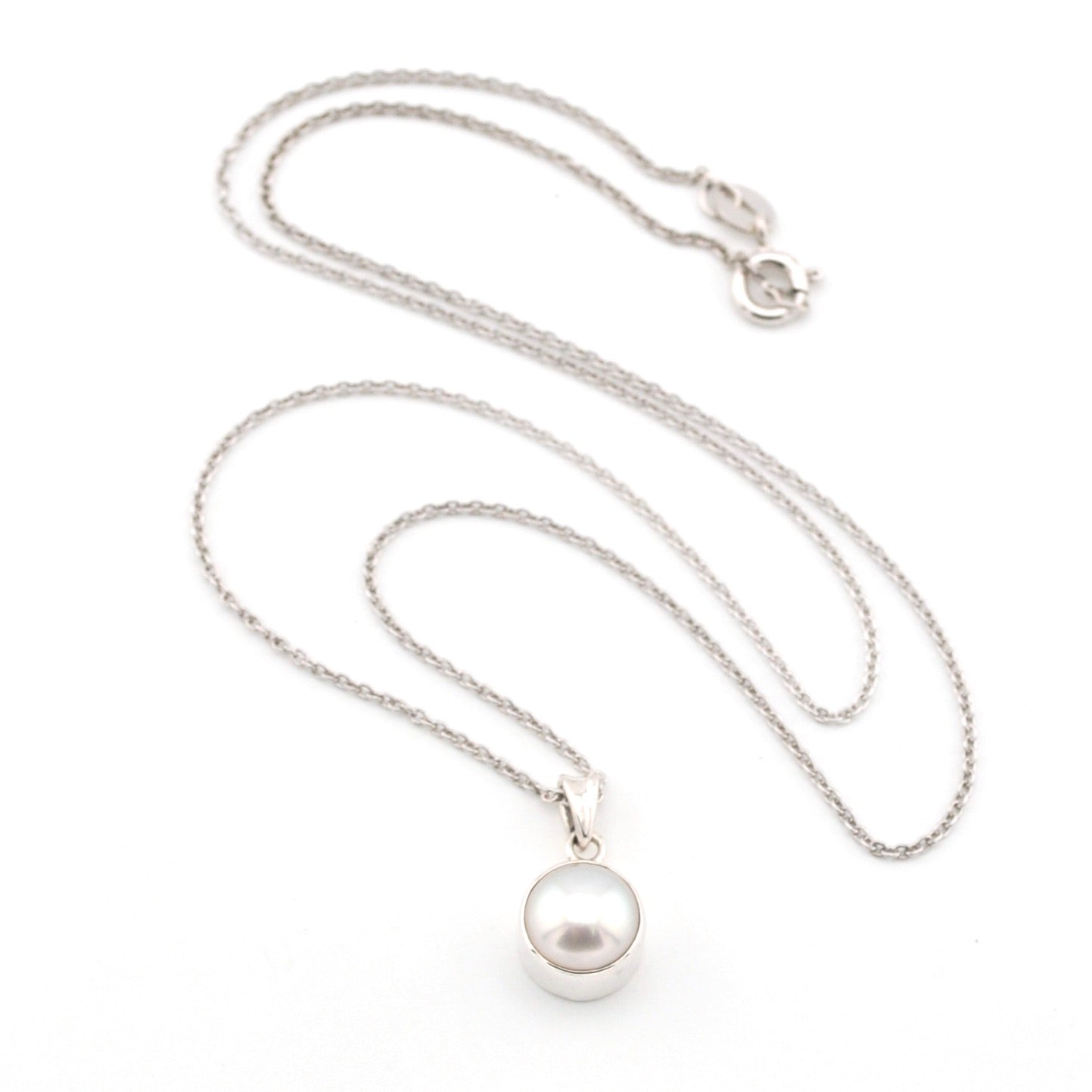 Pearl necklace with a silver chain on a white background