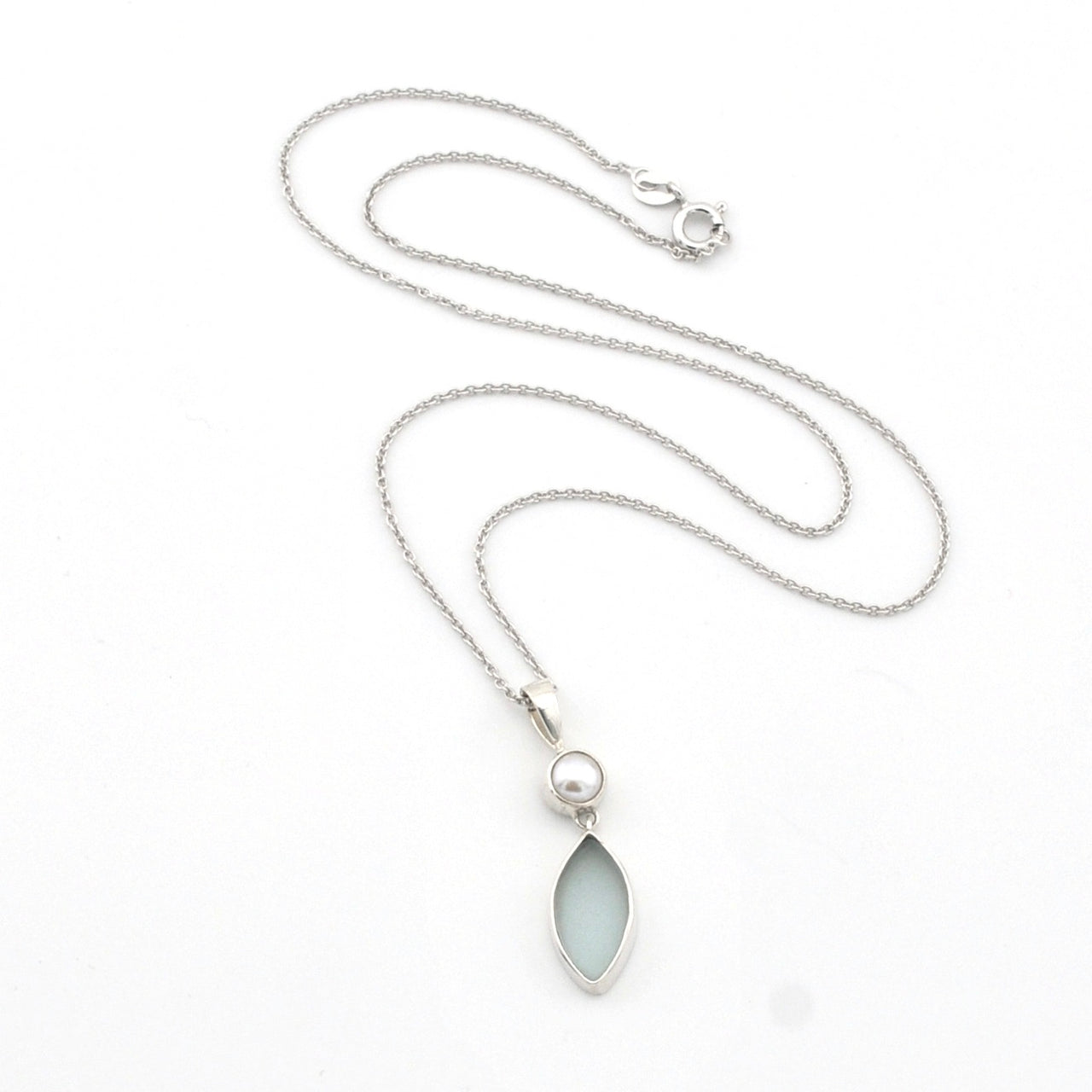 Silver necklace with a teardrop-shaped pendant on a white background