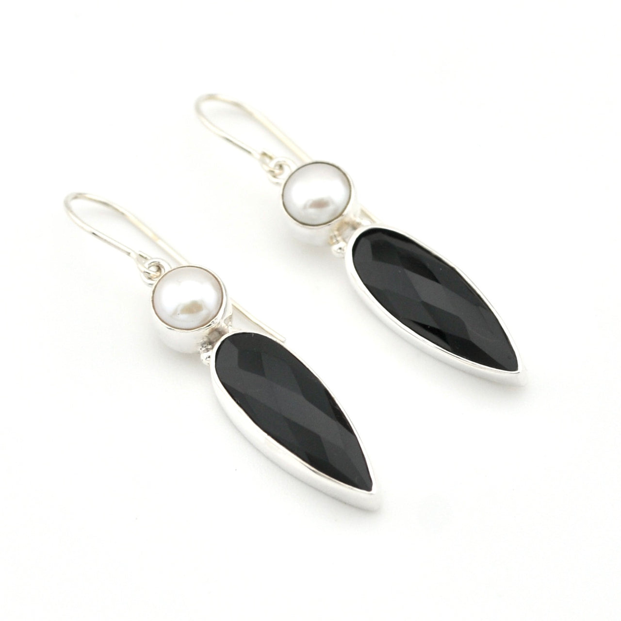 Pair of earrings with black and white stones on a white background