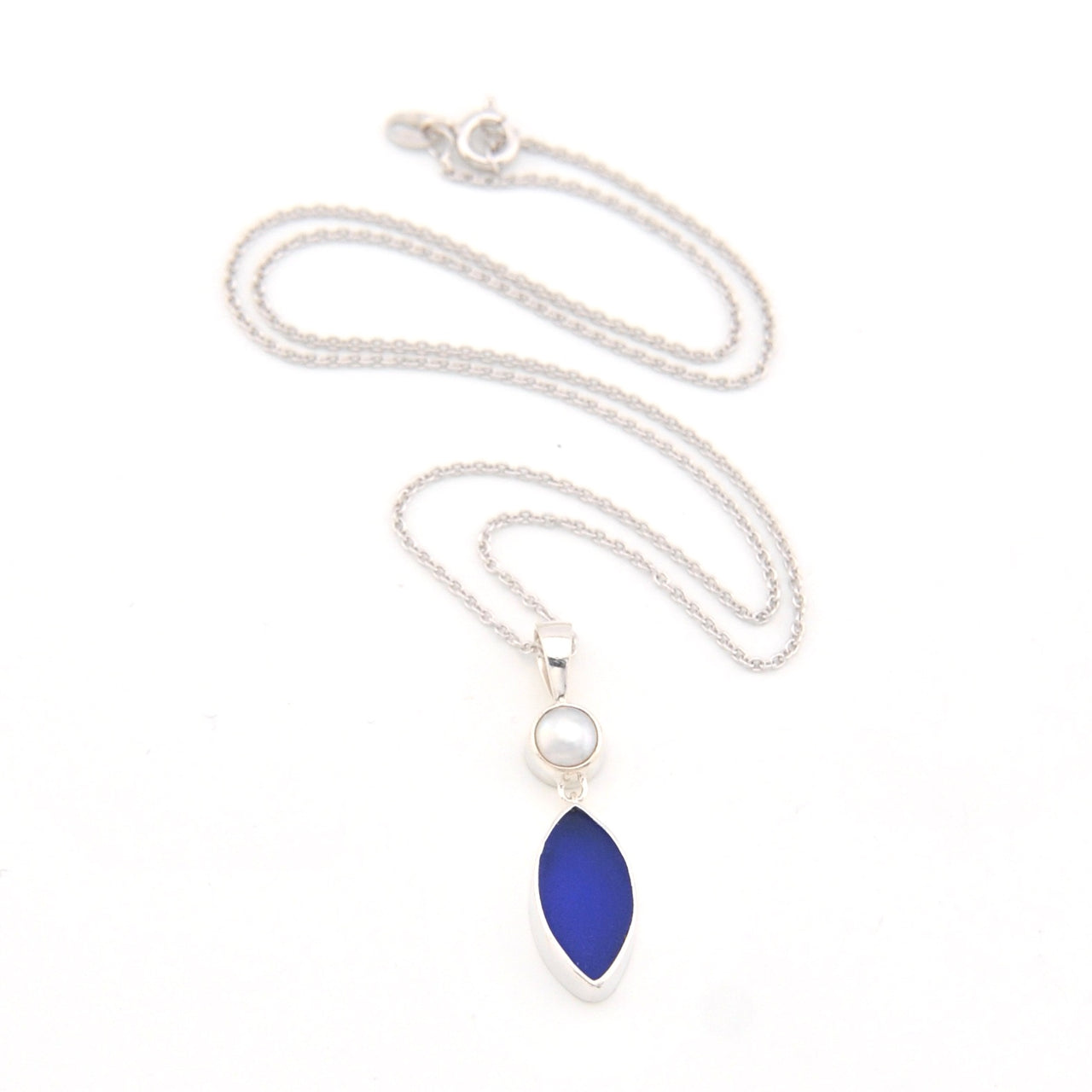Necklace with a blue marquise pendant and pearl on a white background