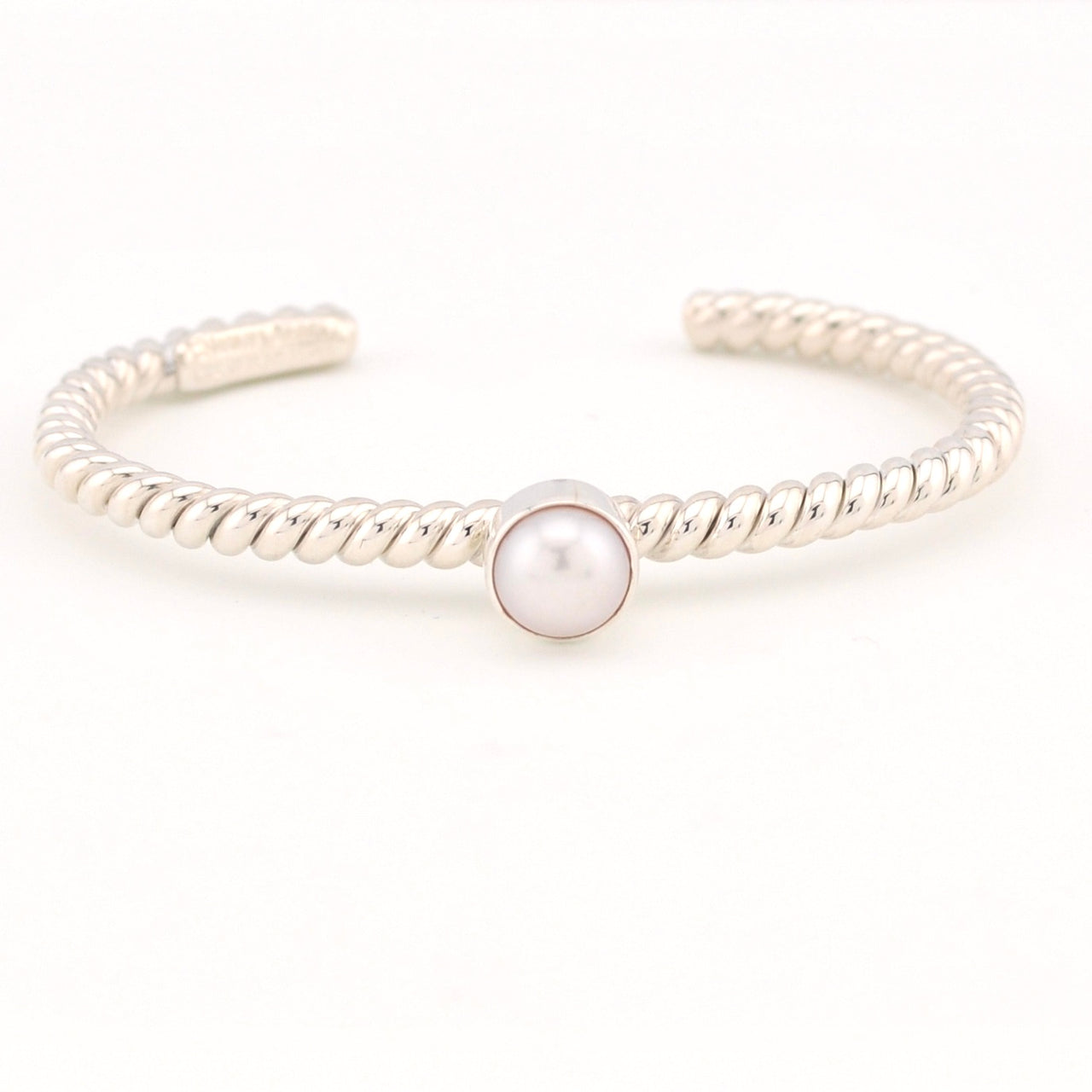 Silver bracelet with a pearl on a white background