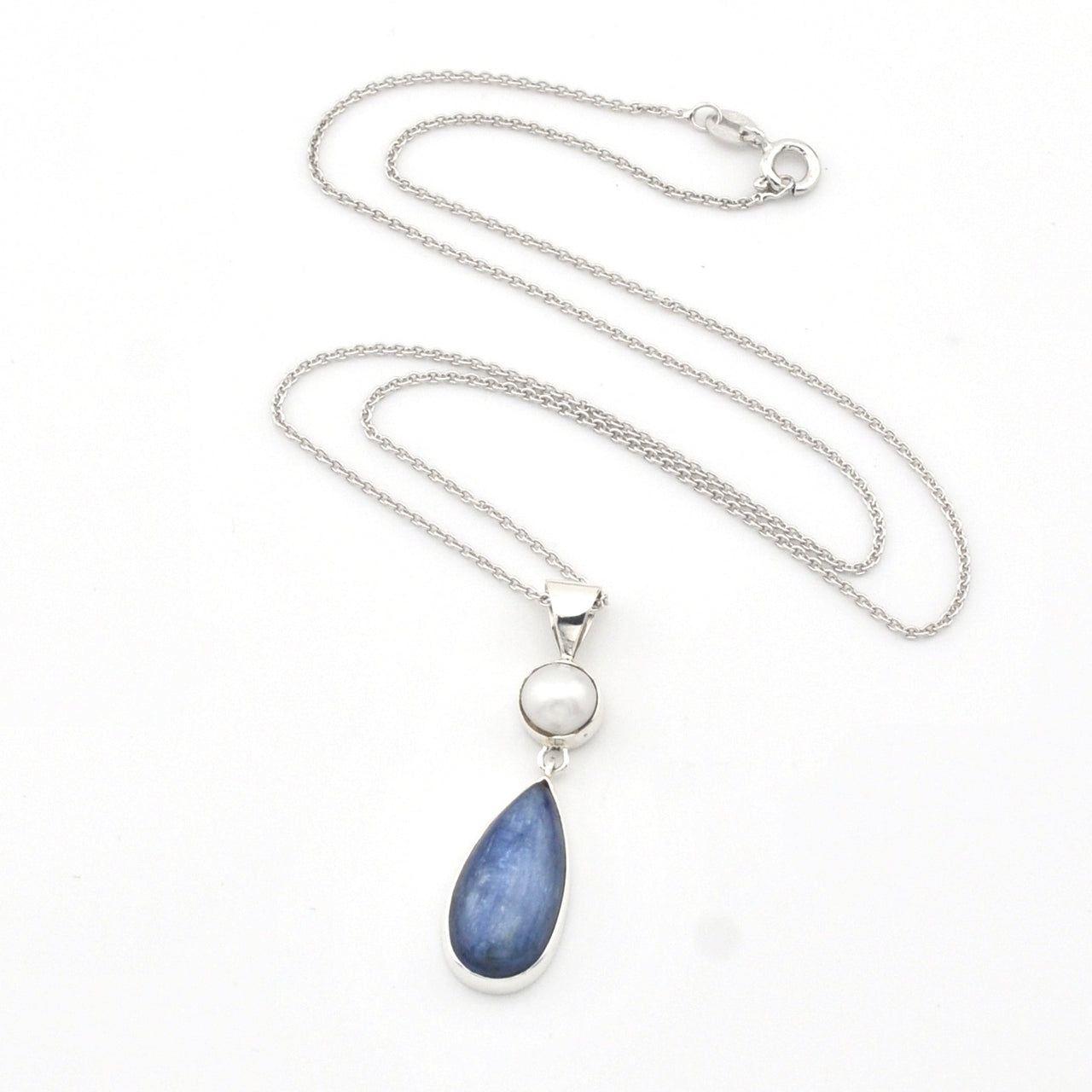 Necklace with a blue teardrop pendant and silver chain on a white background