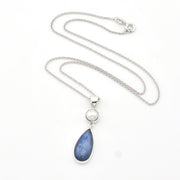 Necklace with a blue teardrop pendant and silver chain on a white background