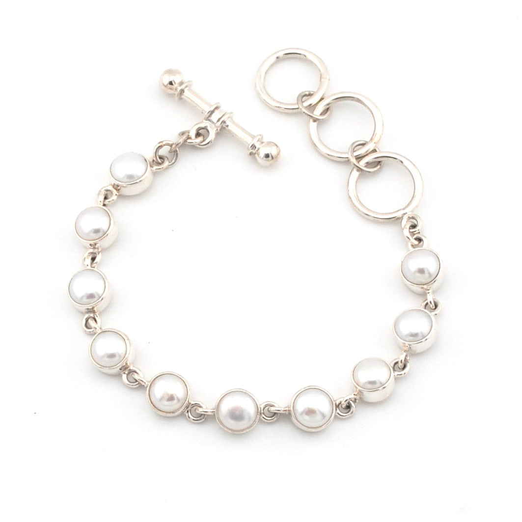 Pearl bracelet with silver clasp on a white background