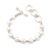 Pearl bracelet with silver clasp on a white background