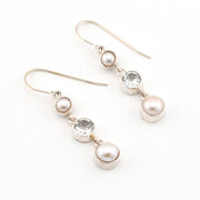 Pair of pearl and topaz drop earrings on a white background
