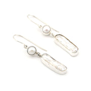 Silver earrings with pearls on a white background