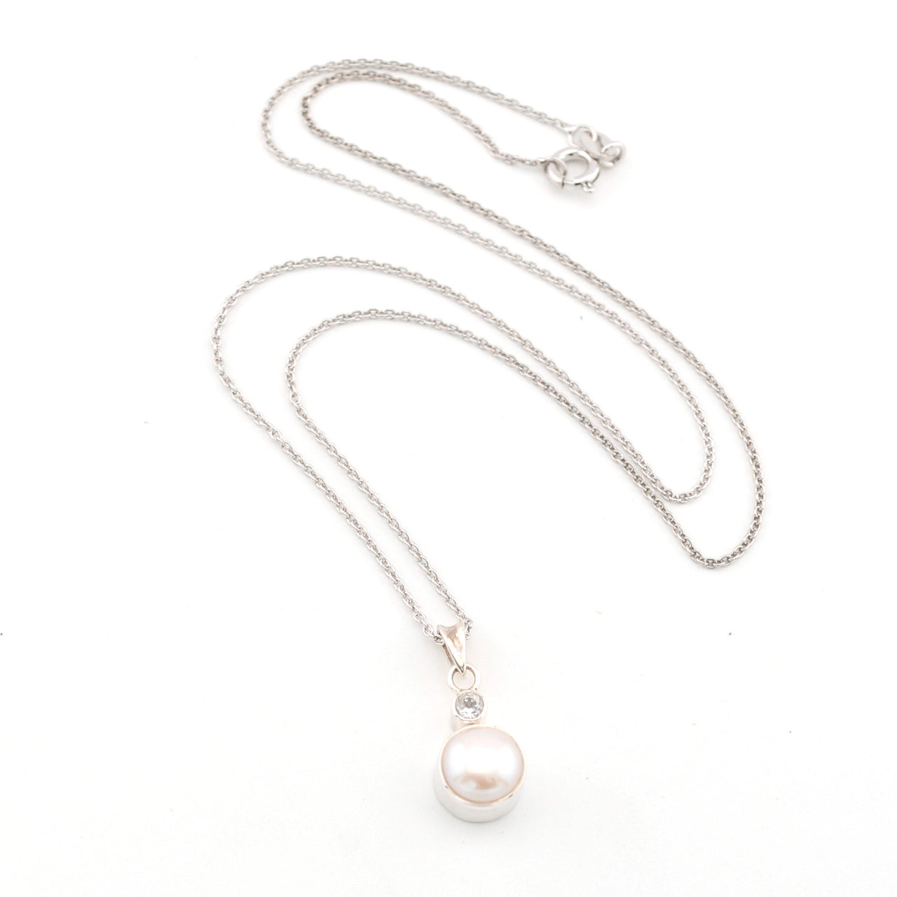 Pearl necklace with silver chain on a white background