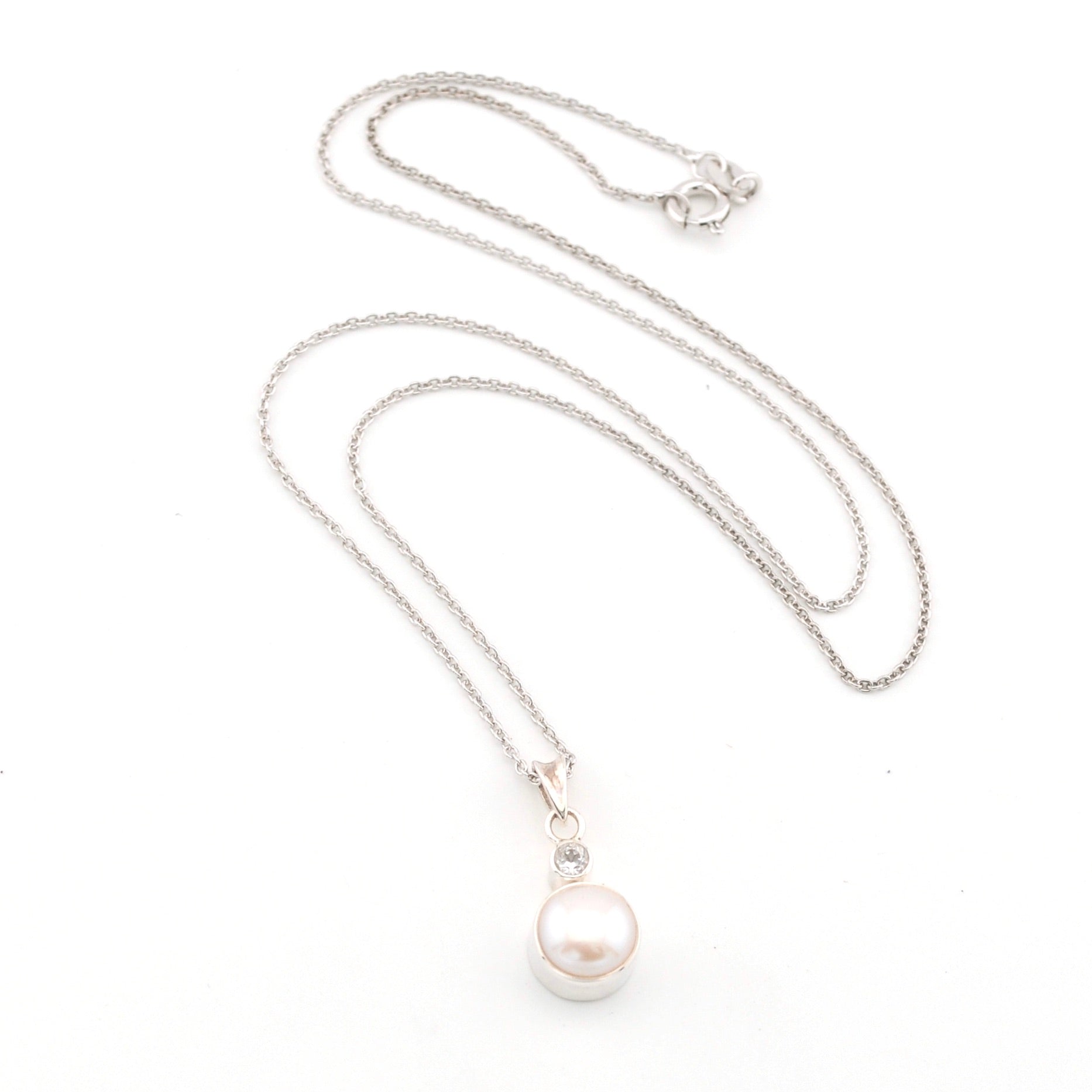 Pearl necklace with silver chain on a white background