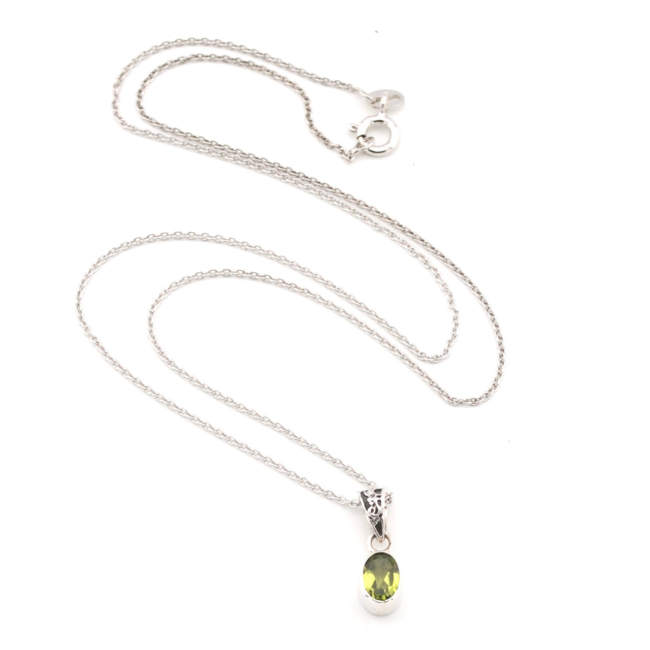Silver necklace with a green peridot gemstone pendant on a white background