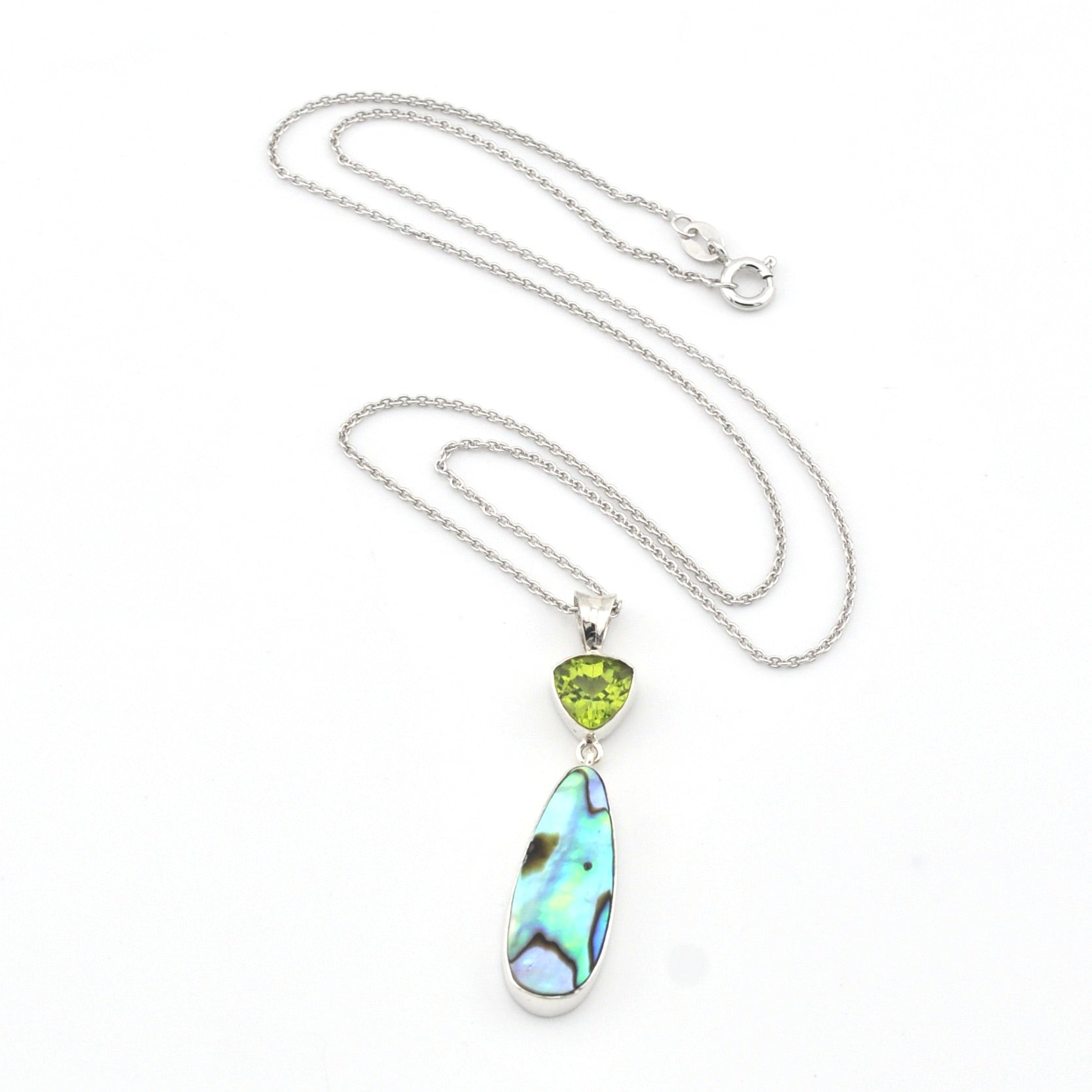 Necklace with a pendant featuring a green gemstone and abalone shell on a white background