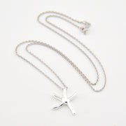 Silver starfish pendant necklace on a white background