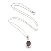 A silver chain necklace with an oval dark reddish-brown gemstone pendant, displayed on a clean white background.