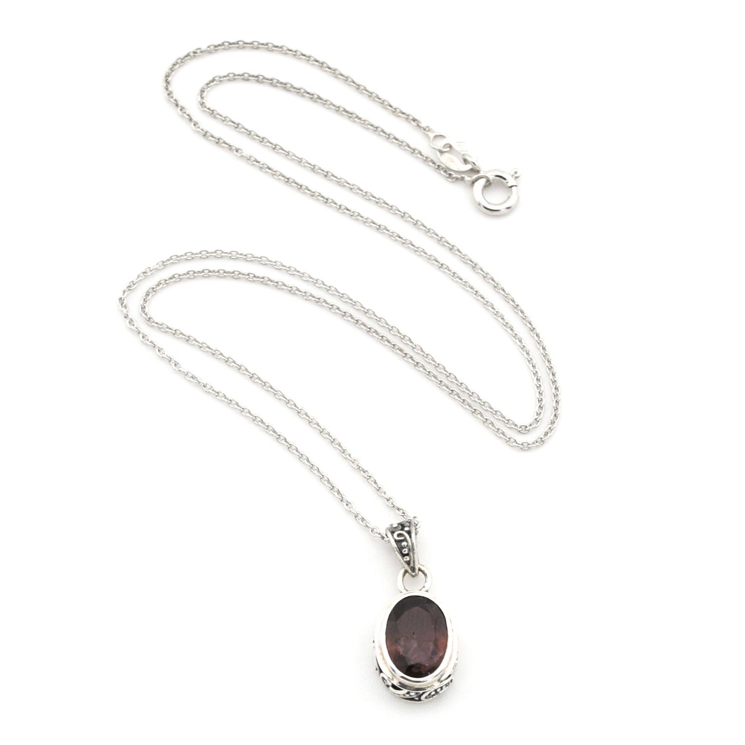 A silver chain necklace with an oval dark reddish-brown gemstone pendant, displayed on a clean white background.