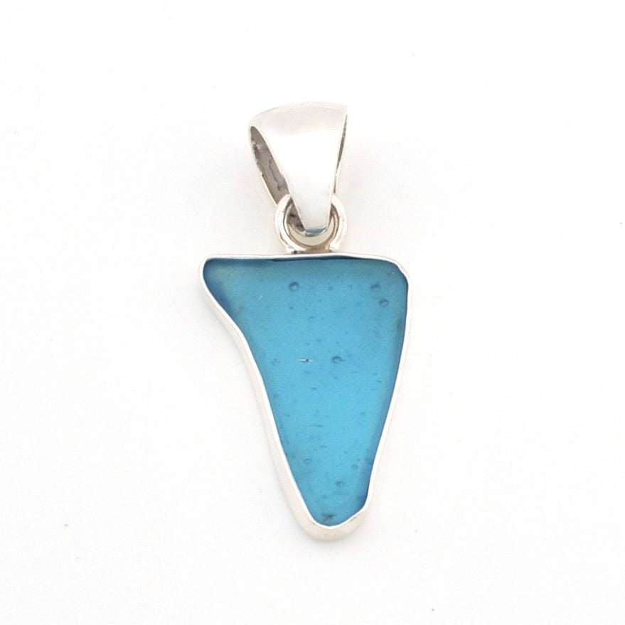 Blue pendant with silver setting on a white background