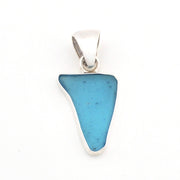 Blue pendant with silver setting on a white background