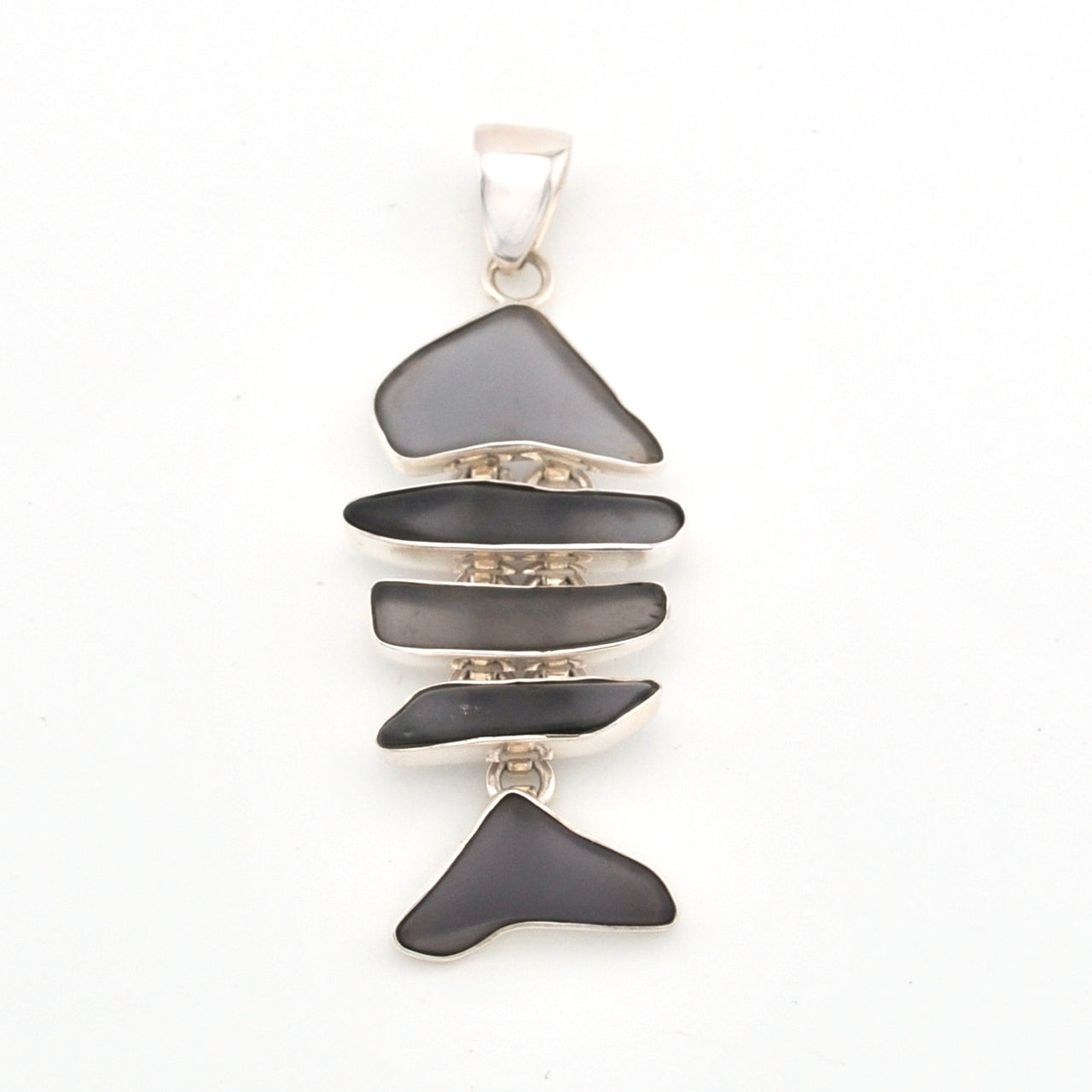 Silver pendant with layered violet glass on a white background