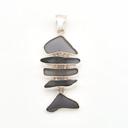 Silver pendant with layered violet glass on a white background
