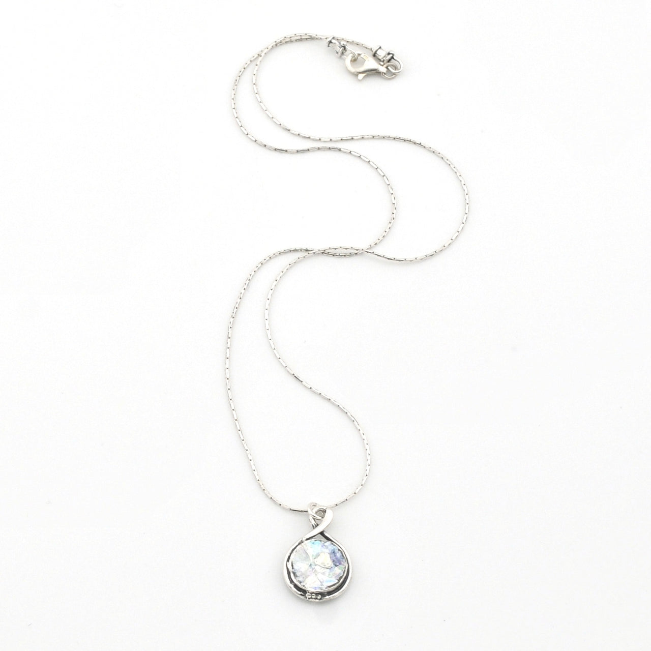 Silver necklace with a teardrop-shaped pendant on a white background
