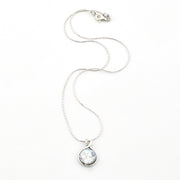 Silver necklace with a teardrop-shaped pendant on a white background