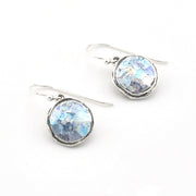 Silver earrings with round blue Roman glass on a white background