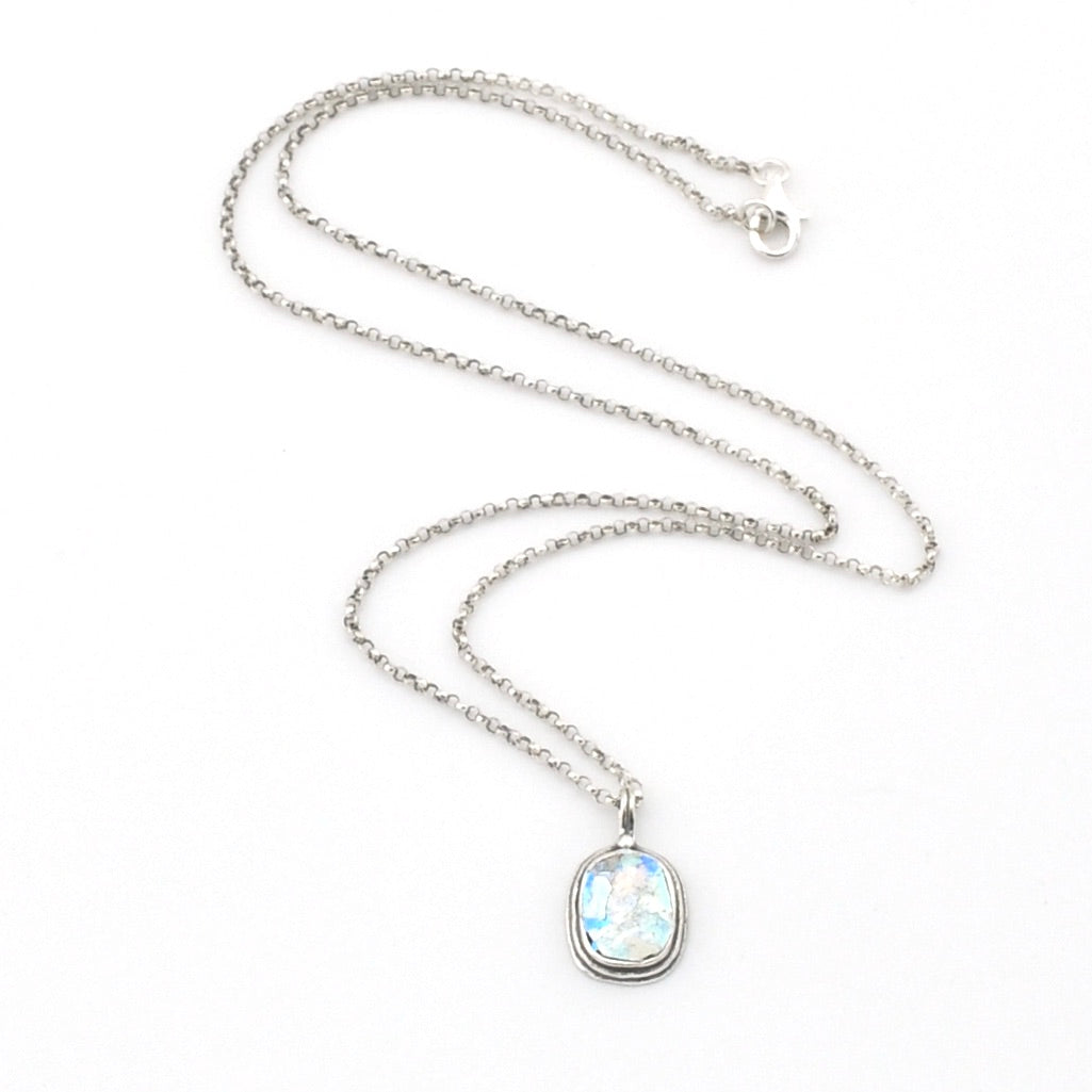 Silver necklace with a pendant on a white background