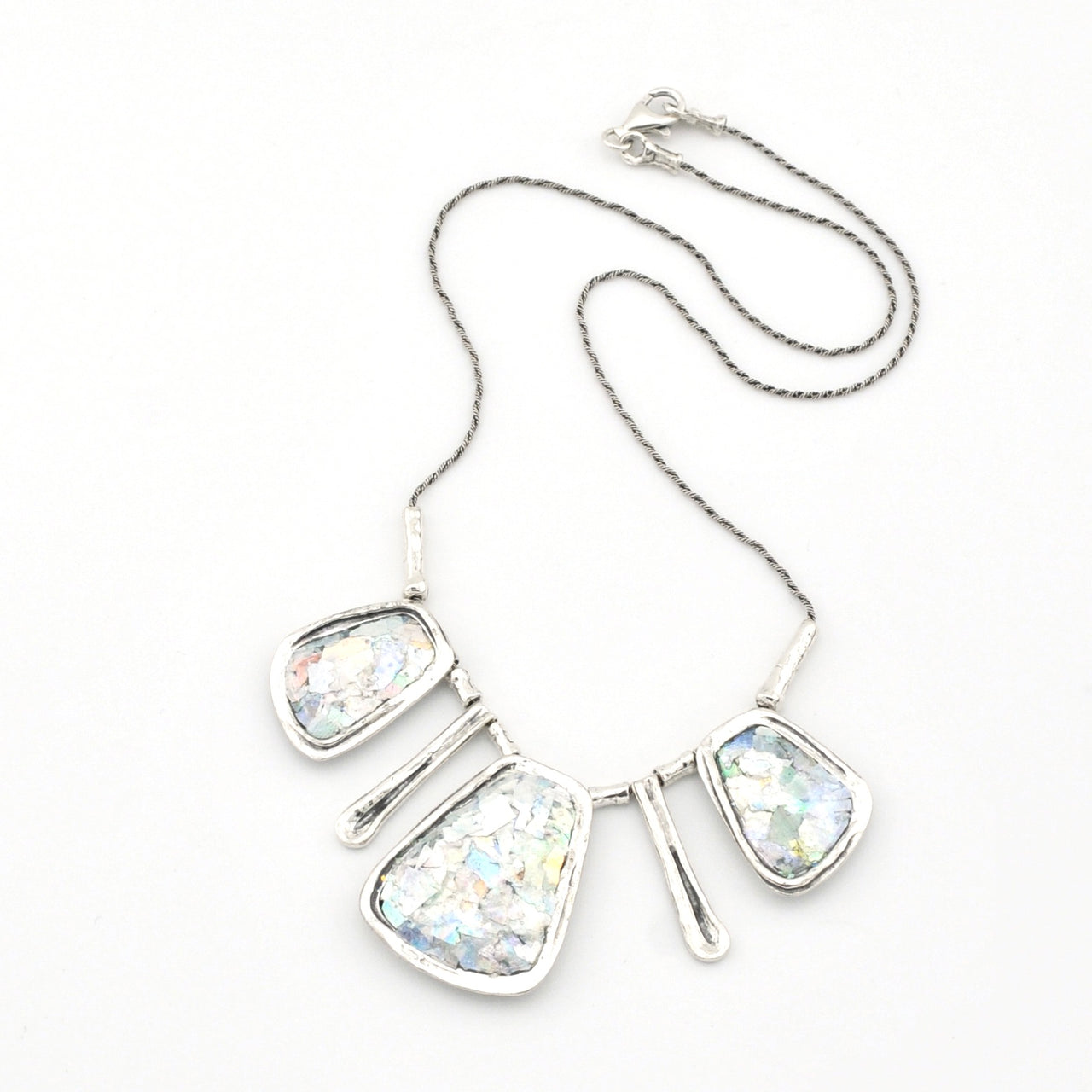Silver necklace with Roman glass on a white background