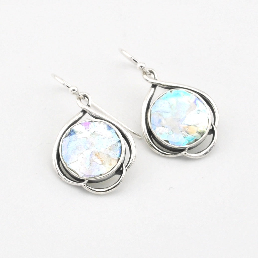 Silver earrings with round glass on a white background