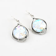 Silver earrings with round glass on a white background