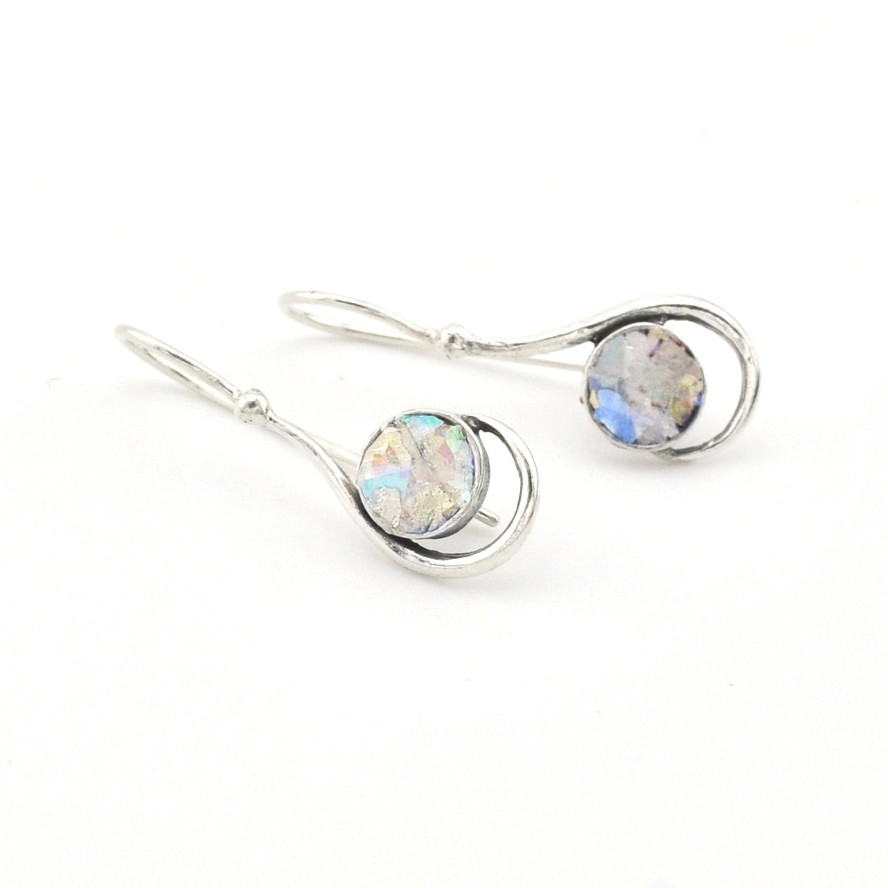 Silver earrings with round gemstones on a white background
