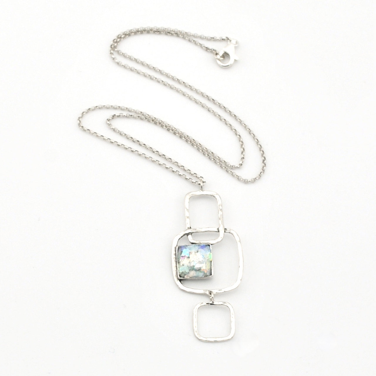 Silver necklace with a rectangular pendant on a white background