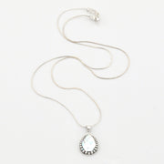 Silver necklace with a teardrop-shaped pendant on a white background