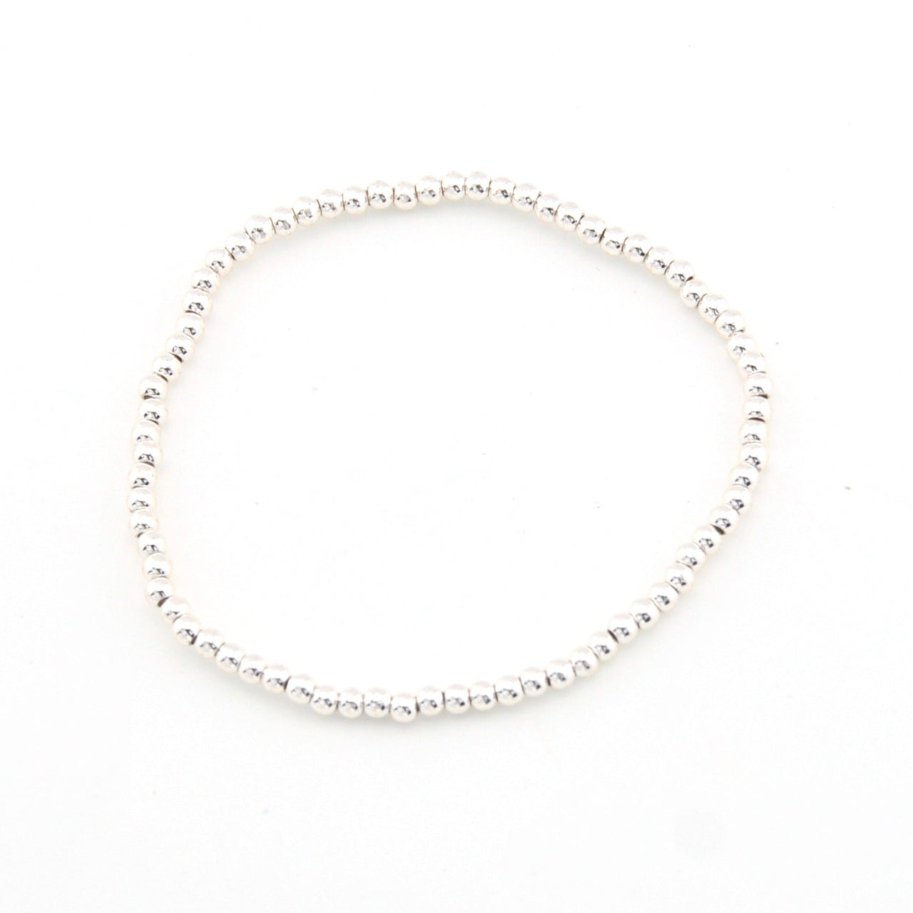 Silver bracelet with small beads on a white background
