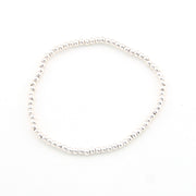 Silver bracelet with small beads on a white background