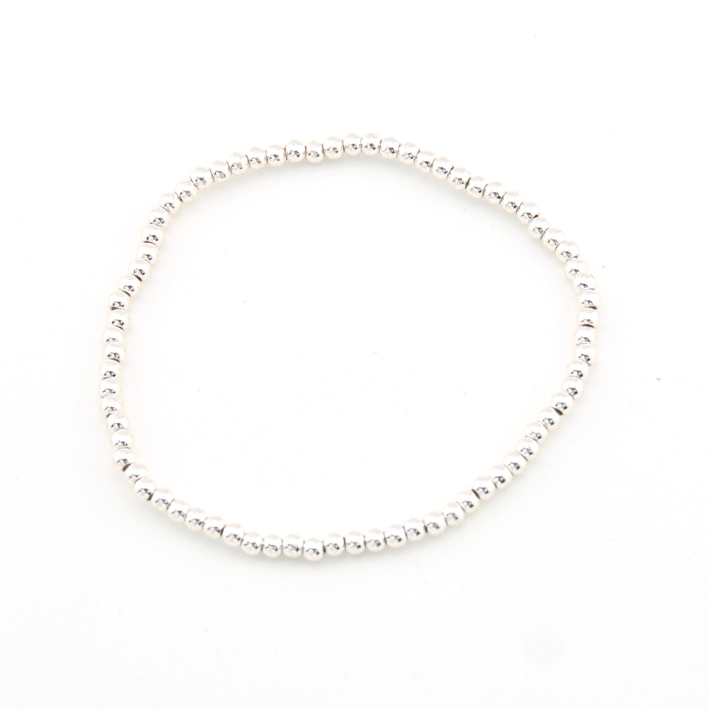 Silver bracelet with small beads on a white background