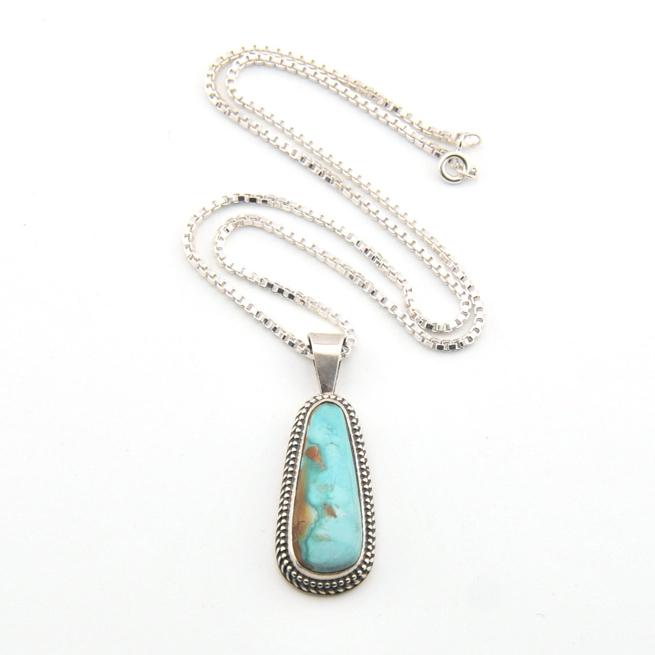 Turquoise pendant necklace on a white background