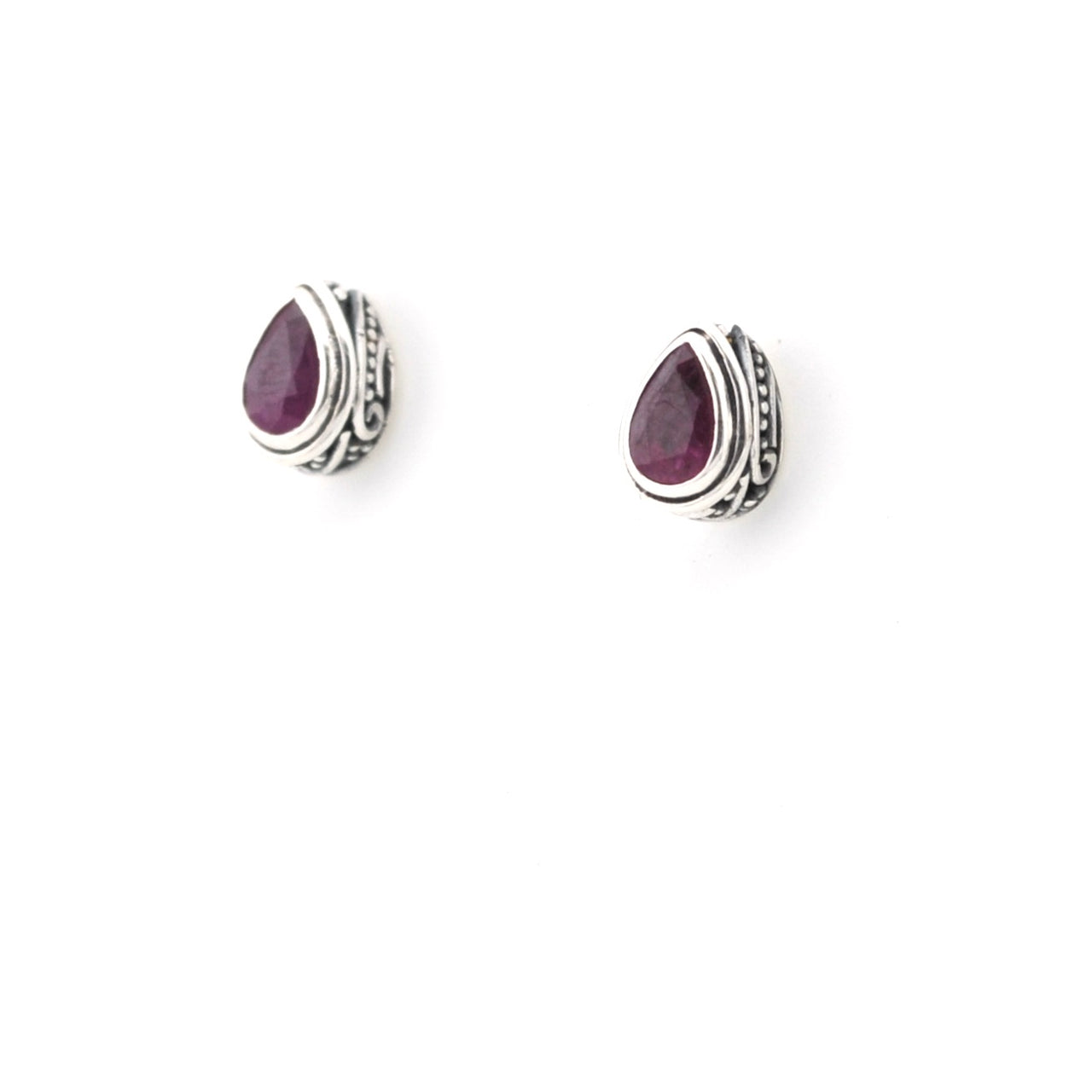 Pair of silver earrings with purple gemstones on a white background