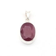 Silver pendant with a purple gemstone on a white background