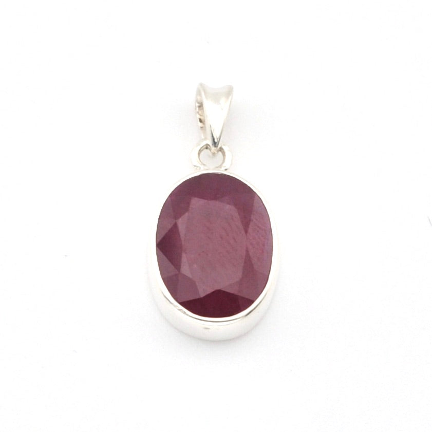 Silver pendant with a purple gemstone on a white background
