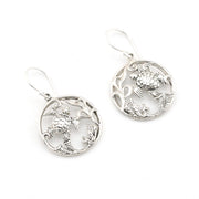 Pair of silver earrings with intricate designs on a white background