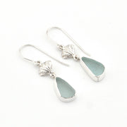 Silver earrings with teardrop-shaped sea glass on a white background
