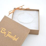 Clear bracelet in a 'Be Jeweled' box on a white background