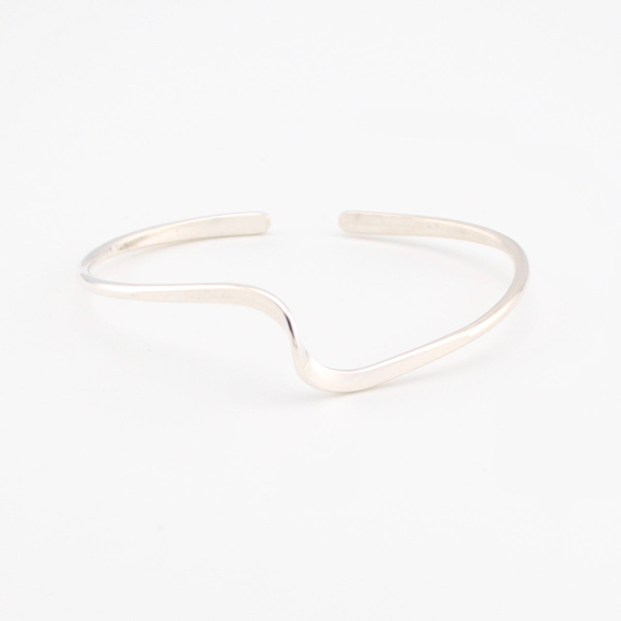 Silver cuff bracelet on a white background