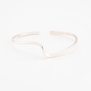 Silver cuff bracelet on a white background