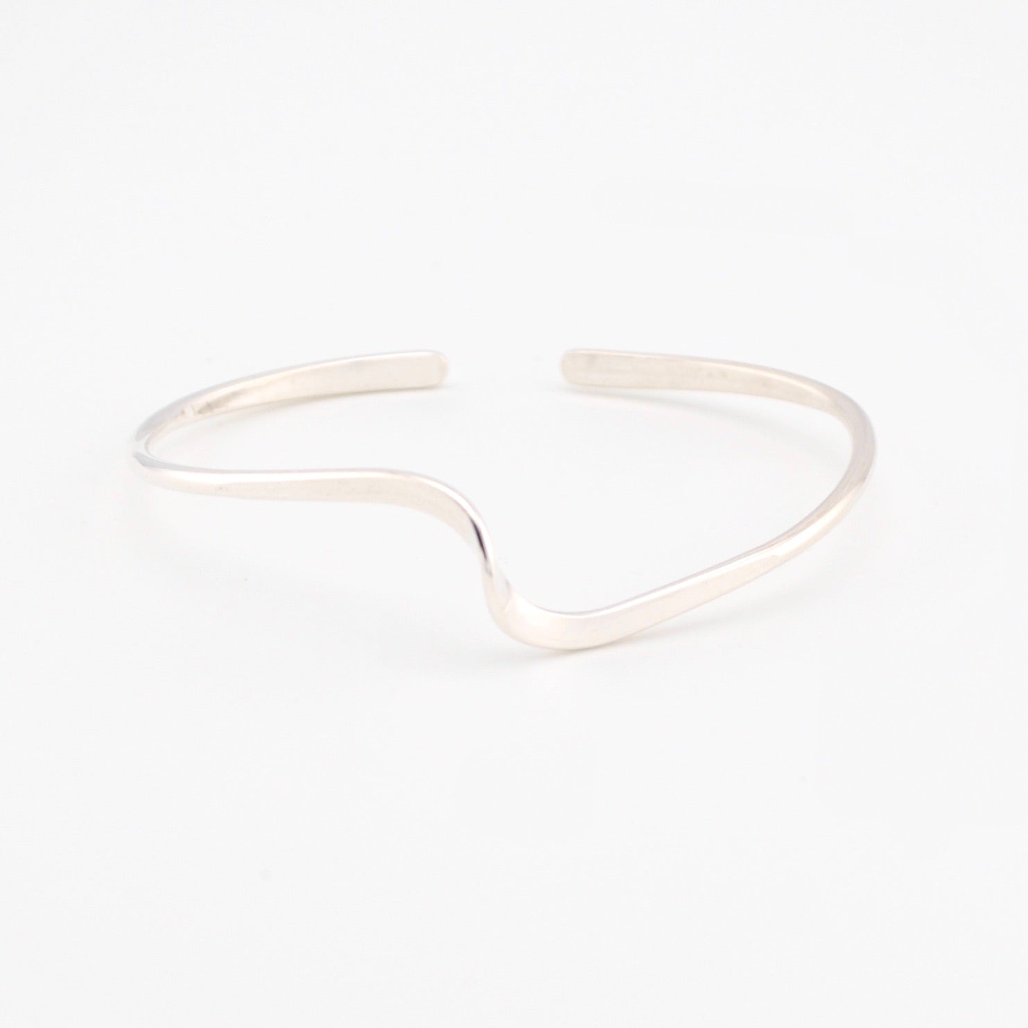 Silver cuff bracelet on a white background